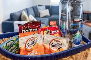 A basket with snacks and Kirkland water bottles. - Swim, Golf & Relax: Beach Apt w/ Private Yard! (Jacksonville Beach)