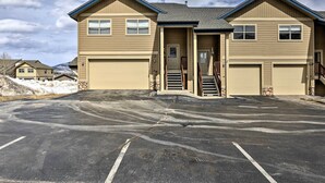A two-story building with a garage, a covered entrance, and a driveway leading to a parking lot. - 11 Mi to Keystone: Silverthorne Condo w/ Deck (Silverthorne)