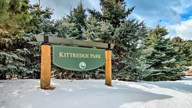 A sign for Kittredge Park surrounded by snow-covered trees. - Near Red Rocks, Hiking & Skiing: Kittredge Condo! (Kittredge)