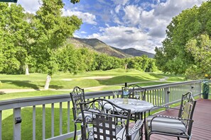 A deck with a table and chairs overlooking a golf course. - Modern Dalton Ranch Golf Club Home w/ Mtn View (Durango)
