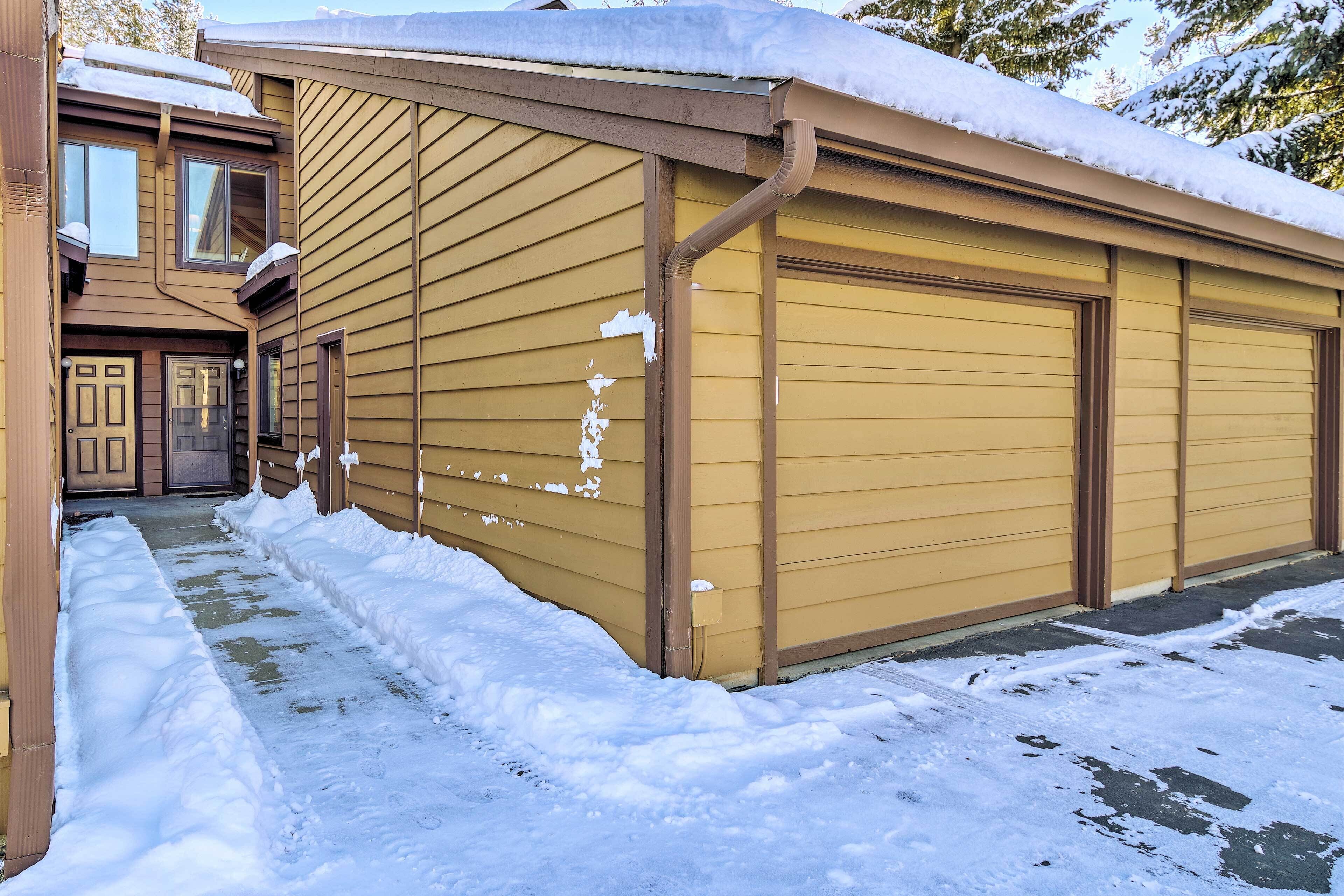 A building with a garage door and a covered driveway.