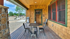 A wooden cabin with a covered porch, stone wall, and a sign reading "Cody Cano Cabin". - Dog-friendly Cabin in the Heart of Grand Lake! (Grand Lake)