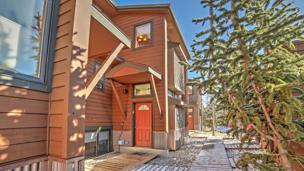A wooden building with a red door, a small porch, and a wooden deck. - Walk to Main Street: Frisco Townhome w/ Decks (Frisco)