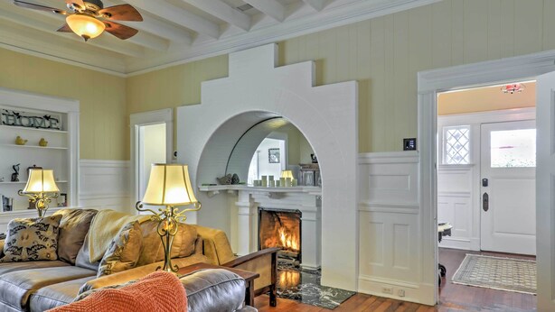 A cozy living room with a fireplace, a sofa, and a coffee table. - Carpinteria Apt w/ Hot Tub - 10 Min Walk to Beach! (Carpinteria)