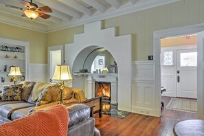 A cozy living room with a fireplace, a sofa, and a coffee table. - Carpinteria Apt w/ Hot Tub - 10 Min Walk to Beach! (Carpinteria)