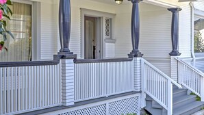 A white house with a porch, columns, and a staircase. - Carpinteria Apt w/ Hot Tub - 10 Min Walk to Beach! (Carpinteria)