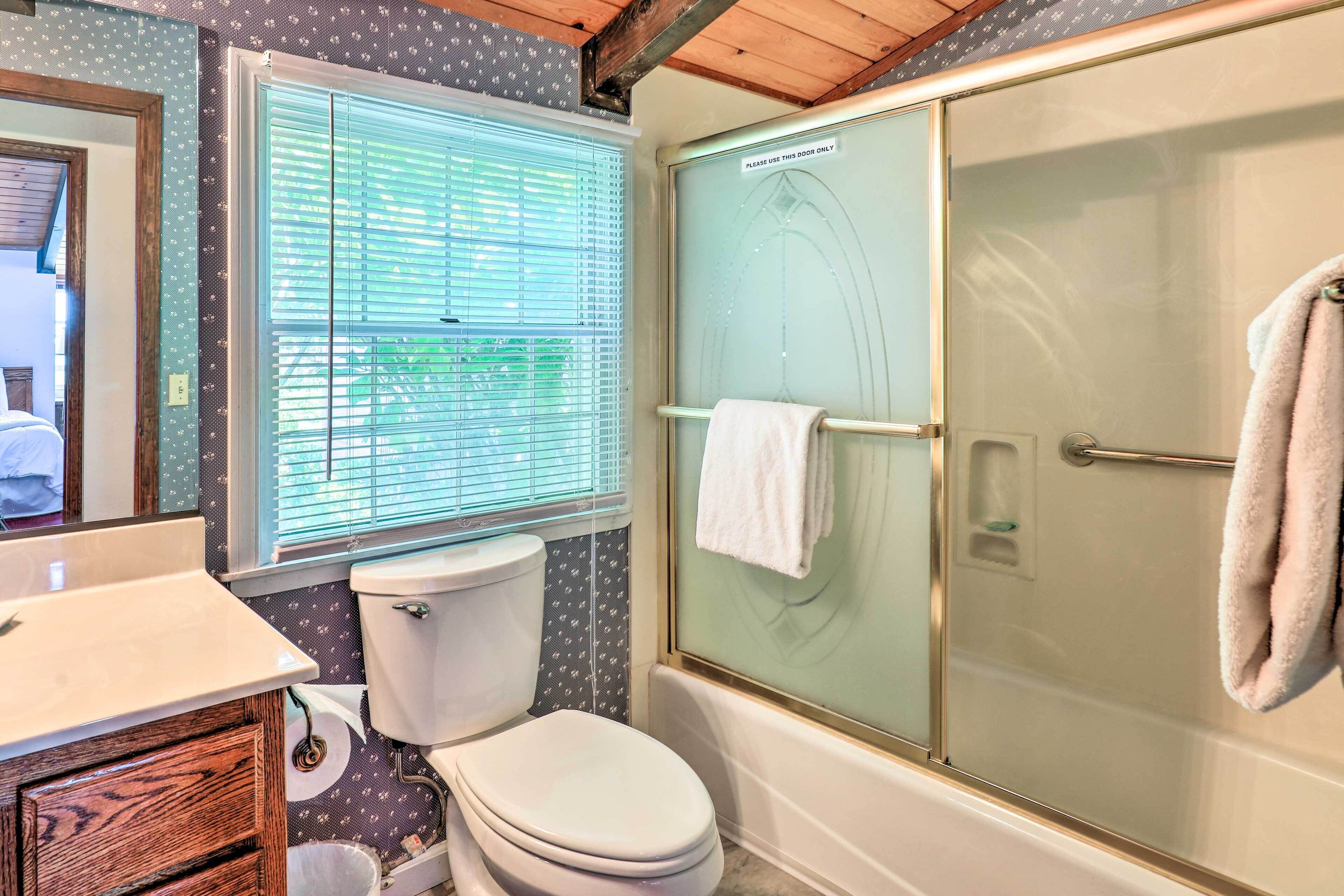 A bathroom with a toilet, sink, and shower.