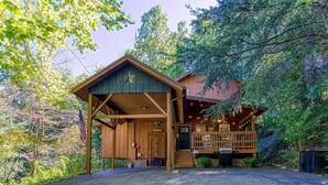 A rustic cabin with a covered porch, a deck, and a driveway. - Cozy Cabin w/ Mountain Views Near Skylift Park! (Gatlinburg)