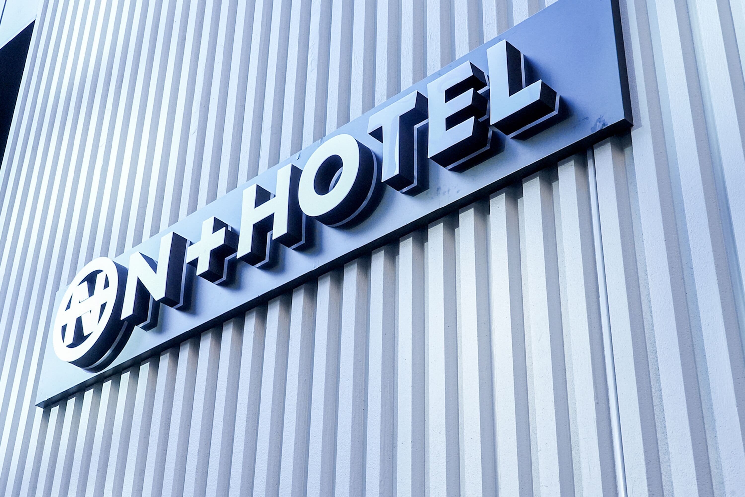 A hotel sign with a modern design and the word "HOTEL" prominently displayed.