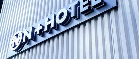 A hotel sign with a modern design and the word "HOTEL" prominently displayed.