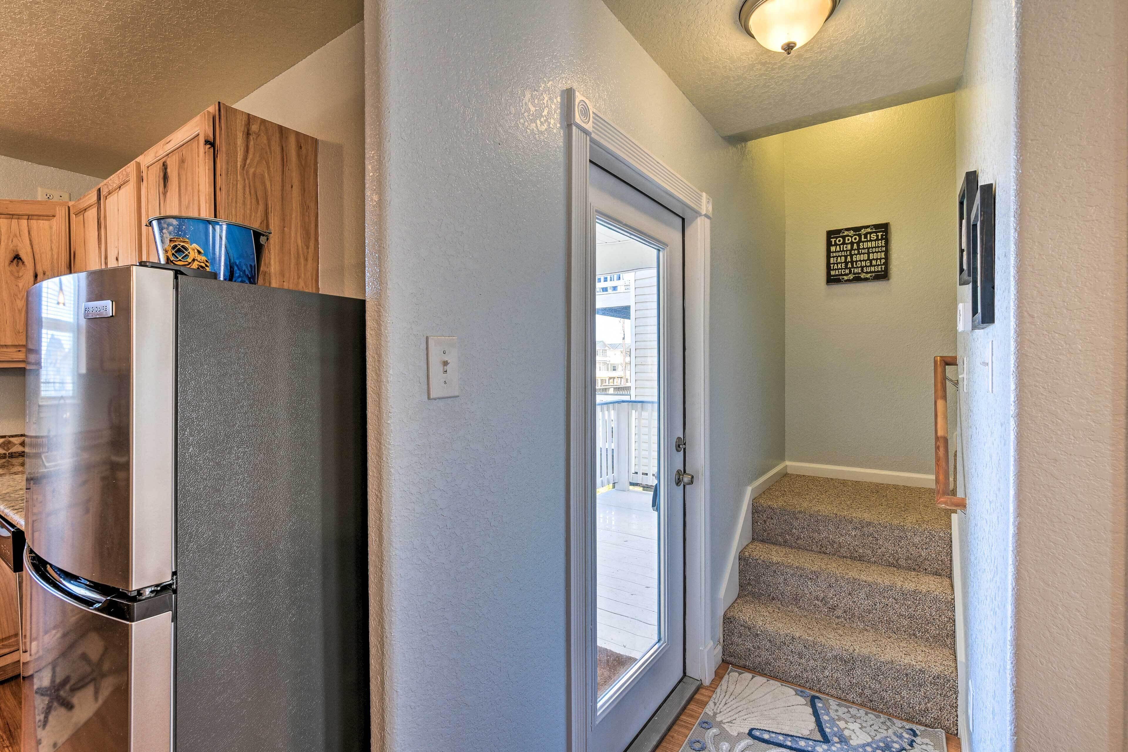 A kitchen with wooden cabinets and a stainless steel refrigerator.