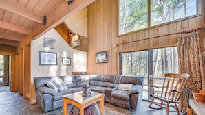 A cozy living room with a sectional sofa, a rocking chair, and a fireplace. - 0.5 Mi to Dtwn & Trails: Conway Condo w/ Hot Tub! (North Conway)