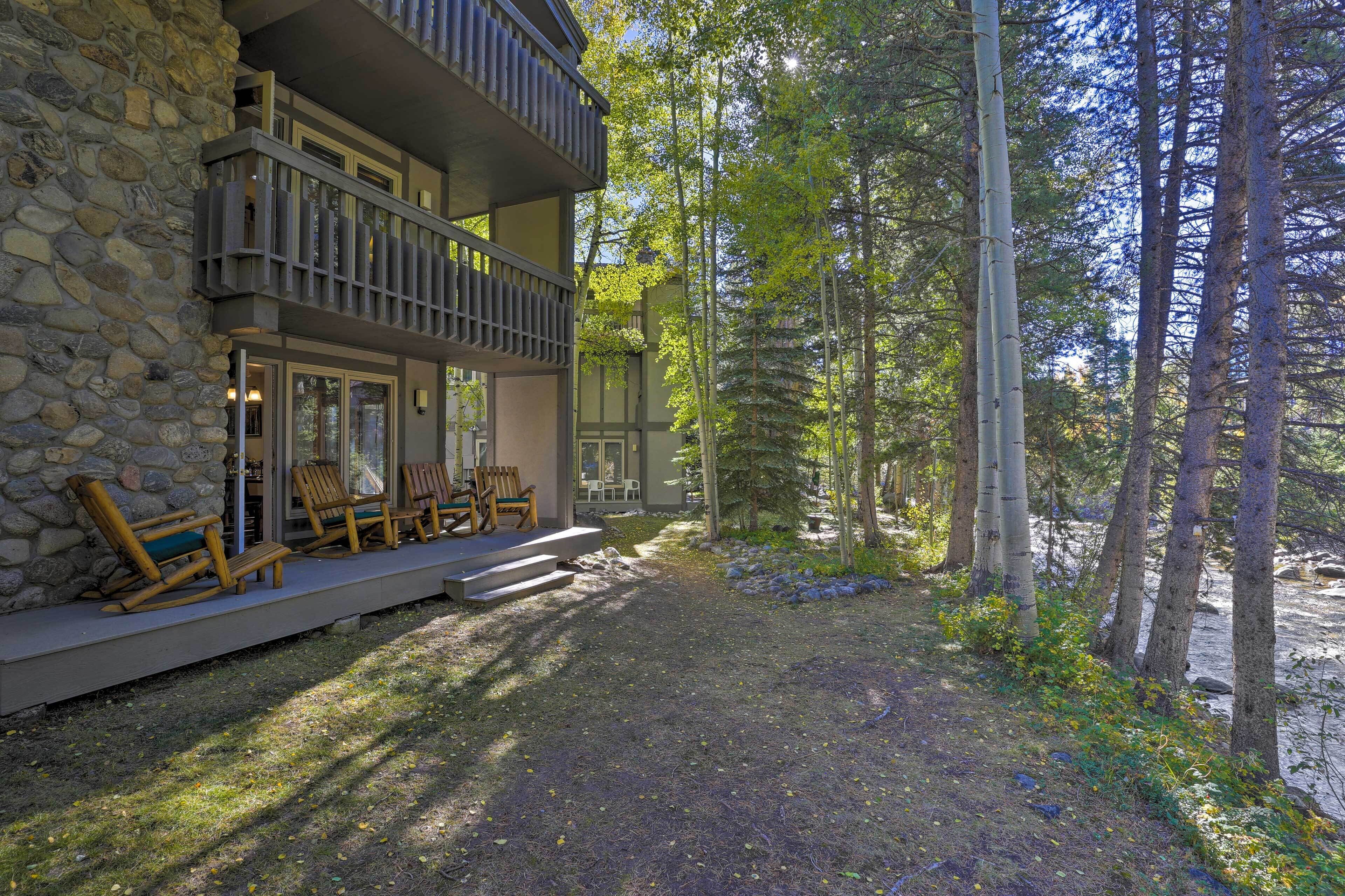 A stone building with a balcony and outdoor seating area.