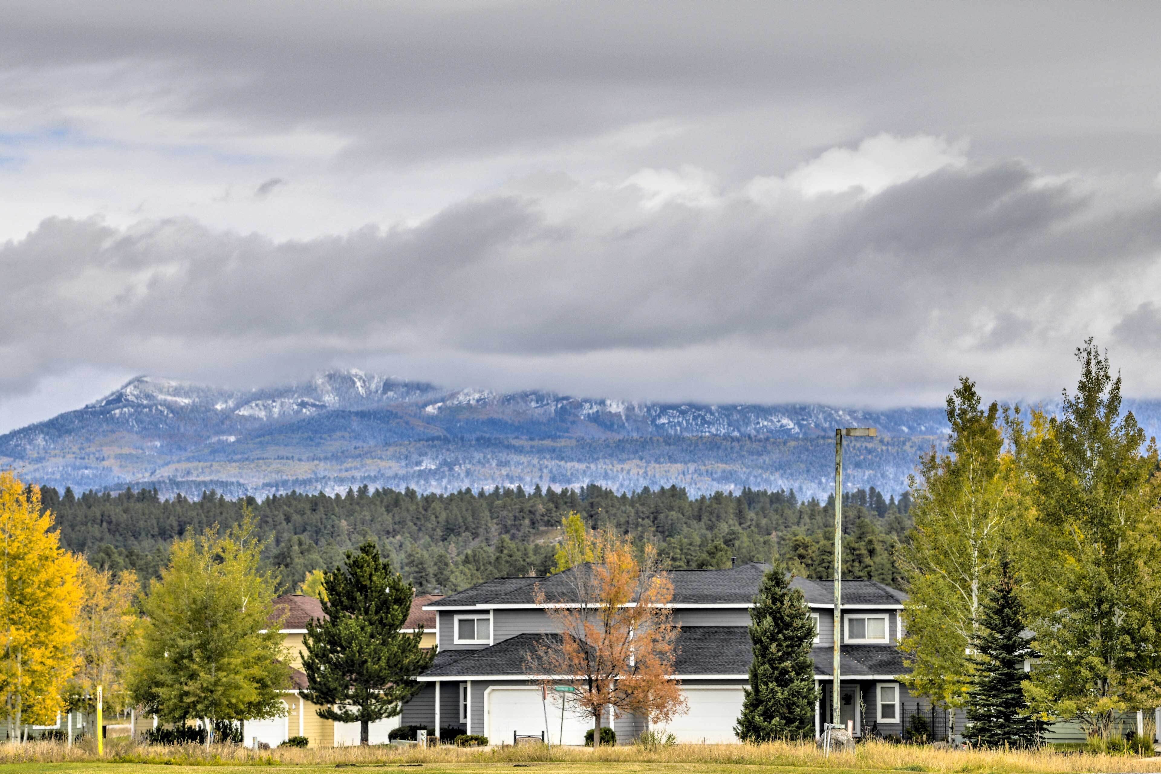 A residential area with houses, a streetlight, and a mountain range in the background.