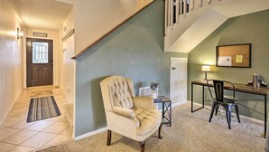 A staircase with a wooden handrail and a beige carpeted landing area. - Pagosa Springs Townhome w/ Mountain Views! (Pagosa Springs)