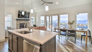 A modern kitchen with a large island, a dining area with a view, and a cozy seating area. - Eden Home w/ Stunning View ~ 6 Mi to Skiing! (Eden)