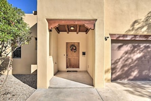 A building entrance with a wooden door, a welcome mat, and a small porch area. - 2 Mi to Downtown Sante Fe: 4BR Retreat w/ Patio (Santa Fe)