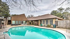 A backyard with a swimming pool, a wooden deck, and a house with a brown roof and windows. - Studio w/ Pool - 13 Mi to Downtown Dallas! (Dallas)