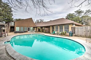 A backyard with a swimming pool, a wooden deck, and a house with a brown roof and windows. - Studio w/ Pool - 13 Mi to Downtown Dallas! (Dallas)