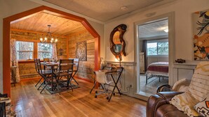 A cozy interior with a wooden dining area, a workspace, and a comfortable seating area. - Colorado Mountain Cabin Near National Forest! (Guffey)