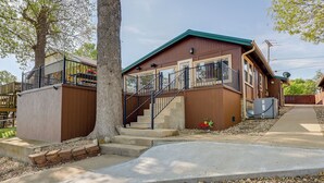 A two-story wooden house with a balcony, a staircase, and a satellite dish. - Grand Lake Waterfront Home: 2 Boat Docks (Grove)