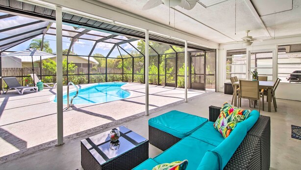 A covered outdoor area with a pool, seating, and a dining area. - Bright Sebastian Home w/ Pool ~ 7 Mi to Beach! (Sebastian)