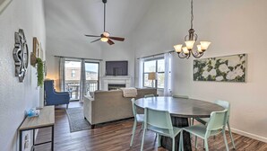 A spacious dining area with a round table and chairs, a ceiling fan, and a chandelier. - Branson Vacation Rental w/ Resort Amenities (Branson)