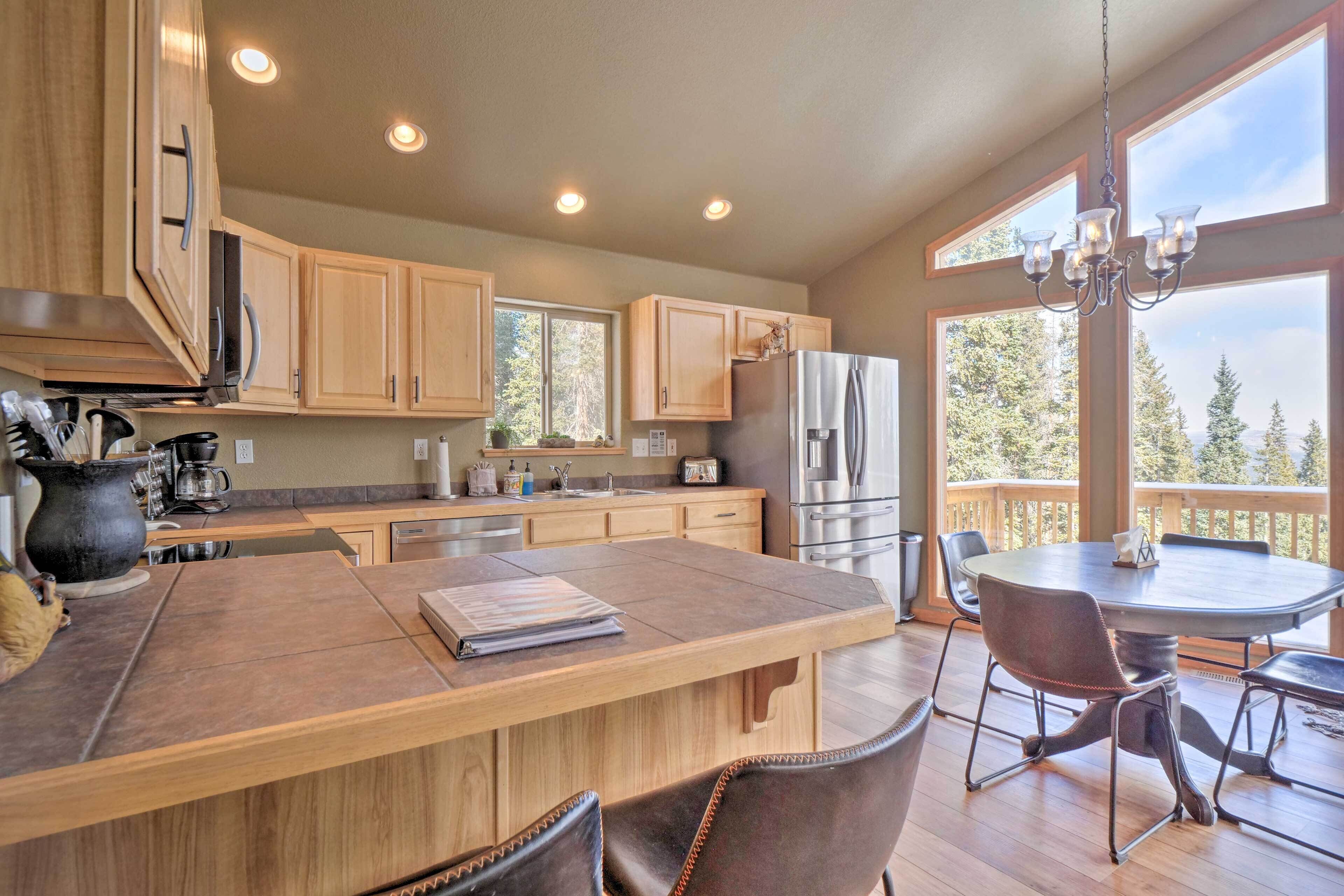 A spacious kitchen with wooden cabinets, a central island, and a dining area with chairs.