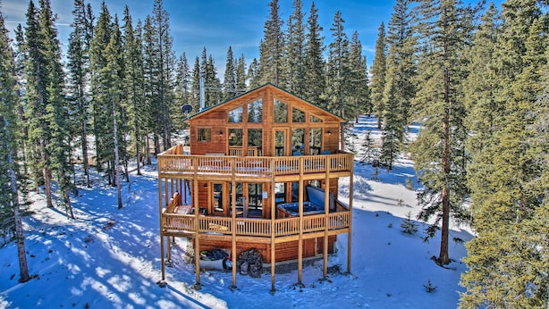 A wooden cabin with a balcony, surrounded by snow and pine trees. - 26-0086 Fairplay Cabin w/ Hot Tub! (Fairplay)