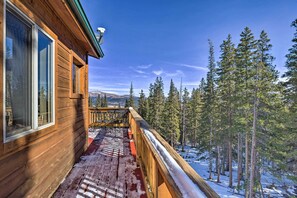 A wooden cabin with a balcony overlooking a snowy forest. - 26-0086 Fairplay Cabin w/ Hot Tub! (Fairplay)
