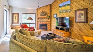 A cozy living room with a fireplace, a television, and comfortable seating. - Cozy Pagosa Springs Townhome w/ Patio! (Pagosa Springs)