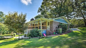 A two-story house with a covered porch, brick exterior, and a small front yard with a hammock and a slide. - Clemson Getaway < 3 Mi to Memorial Stadium! (Clemson)