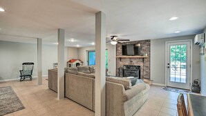 A spacious living room with a fireplace, a large TV, and a dining area. - Clemson Getaway < 3 Mi to Memorial Stadium! (Clemson)