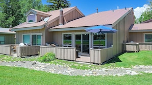 A house with a covered patio, a deck, and a stone pathway. - Colorful Condo in Pagosa Springs w/ Patio! (Pagosa Springs)