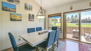 A dining area with a table, chairs, and a view of the outdoors through a sliding glass door. - Colorful Condo in Pagosa Springs w/ Patio! (Pagosa Springs)