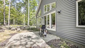 A house with a patio area, outdoor seating, and a grill. - Door County Family Home: 3 Mi Whitefish Dunes (Sturgeon Bay)