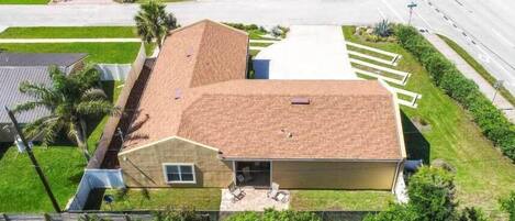 A two-story house with a garage, a driveway, and a well-maintained lawn.