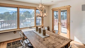 A dining area with a wooden table, three candle holders, and a chandelier. - Buena Vista Oasis w/ Mtn Views, 3 Mi to Dtwn! (Buena Vista)