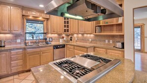 A modern kitchen with wooden cabinets, a built-in stove, and a dishwasher. - Buena Vista Oasis w/ Mtn Views, 3 Mi to Dtwn! (Buena Vista)