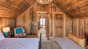 A wooden room with a bed, a chair, a dresser, and a chandelier. - Buena Vista Oasis w/ Mtn Views, 3 Mi to Dtwn! (Buena Vista)