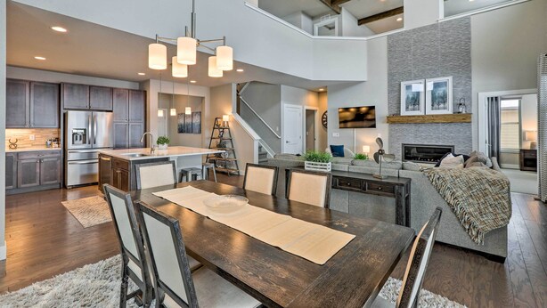 A spacious kitchen with modern appliances, a dining area with a wooden table, and a cozy living space with a fireplace. - Granby Golf Retreat w/ Ski Trails, Mountain View! (Granby)