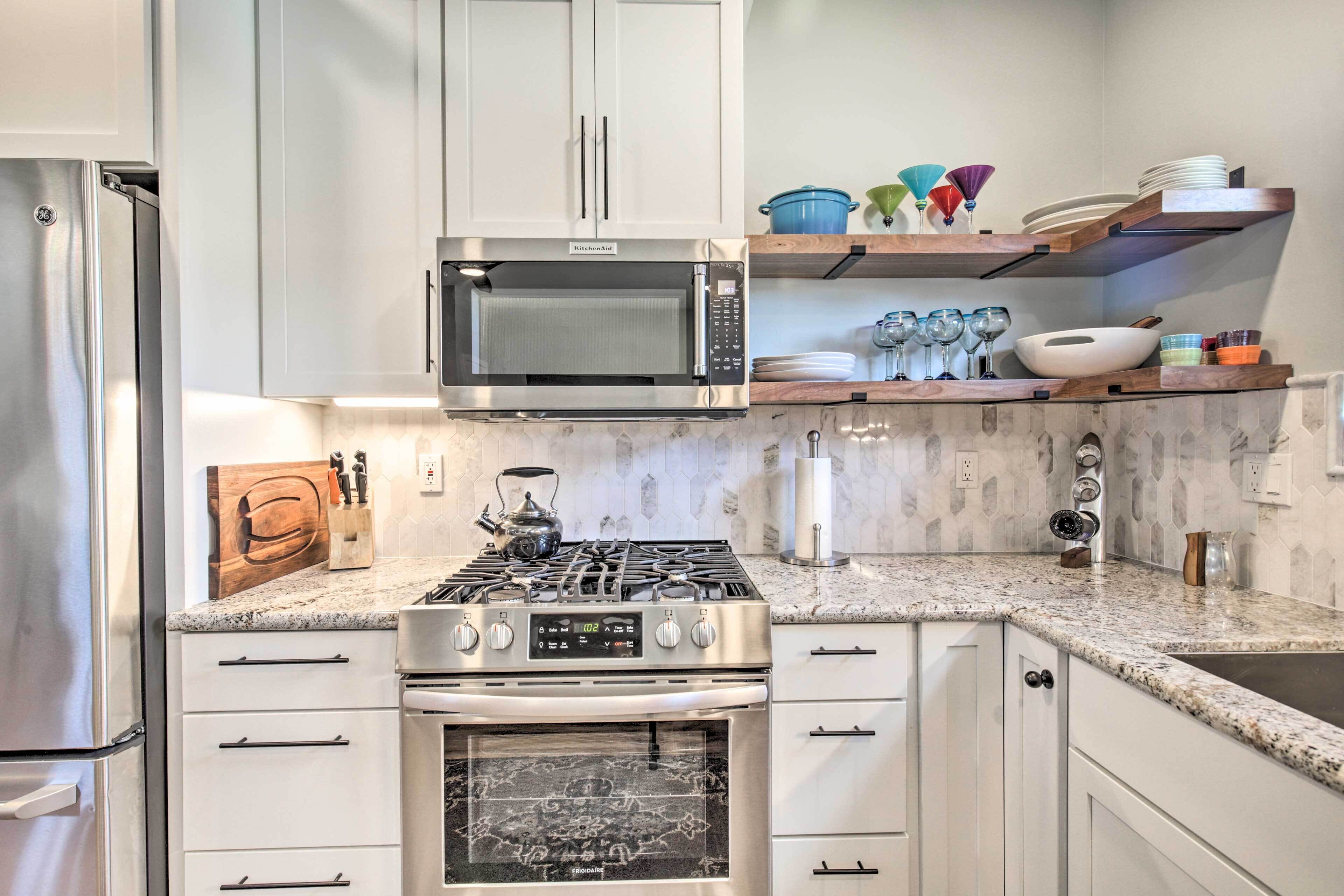 A modern kitchen with stainless steel appliances, a gas stove, a built-in oven, and a microwave.