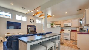 A modern kitchen with a central island, built-in appliances, and a large window. - Luxe Pasadena Casita w/ Fireplace & Grill (Pasadena)