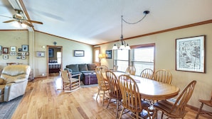 A dining area with a wooden table and chairs, a ceiling fan, and framed pictures on the walls. - Hermosa Home w/ Deck: 2 Mi to Custer State Park! (Hermosa)