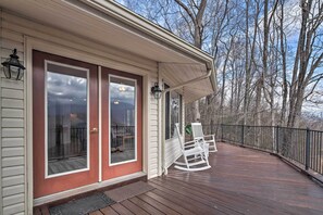 A wooden deck with white rocking chairs and a metal railing. - Charming Burnsville Apt w/ Mountain Views & Deck! (Burnsville)