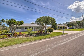 A residential street with houses, a clear sky, and power lines. - Pet-friendly Sebastian Home on Lake; Golf Nearby (Sebastian)