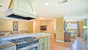 A spacious kitchen with a central island, built-in oven, and a large stove. - Charming Lafayette Home ~ 5 Mi to Downtown! (Lafayette)