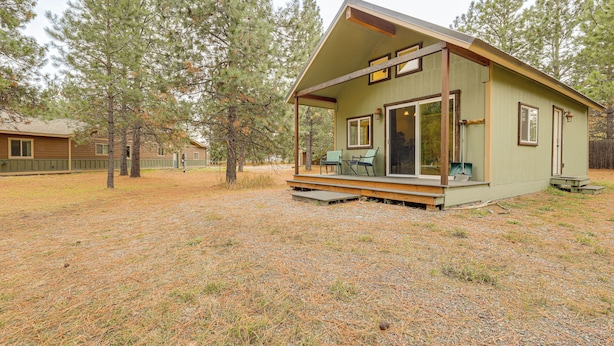 A small cabin with a porch, large windows, and a covered outdoor seating area. - Kalispell Cabin 28 Miles to Glacier National Park! (Kalispell)
