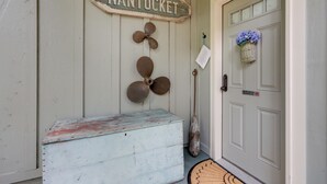 A door with a 'Nantucket' sign, a rustic bench, and a 'No Smoking' sign. - 'nantucket Cottage' w/ Fishing Dock + Sunsets (Fernandina Beach)