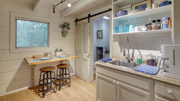 A kitchen with a wooden countertop, a sink, and a window overlooking a forest. - 'nantucket Cottage' w/ Fishing Dock + Sunsets (Fernandina Beach)